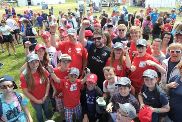 Children with Guy Endean of Emirates Team New Zealand  Picture: Paul Jacobs (160264-28)