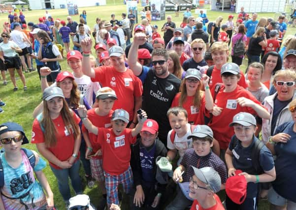 Children with Guy Endean of Emirates Team New Zealand  Picture: Paul Jacobs (160264-28)