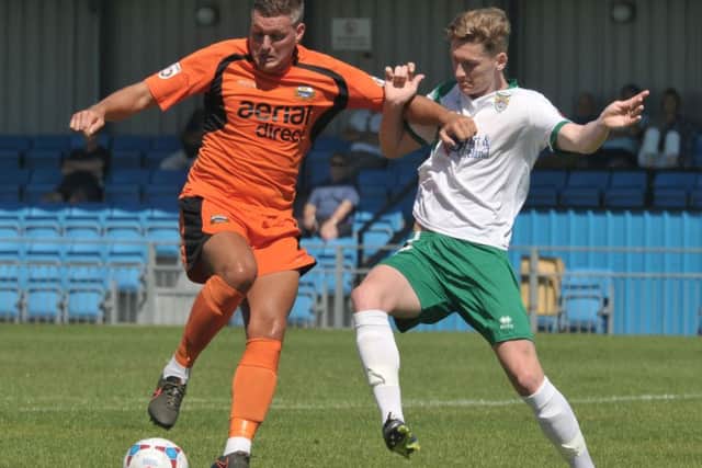 Hat-trick hero Ben Wright holds off his Bognor marker on Saturday. Picture: Mick Young