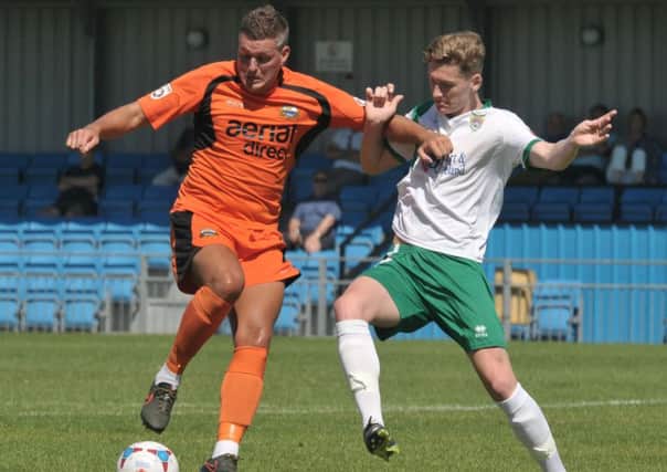 Hat-trick hero Ben Wright holds off his Bognor marker on Saturday. Picture: Mick Young