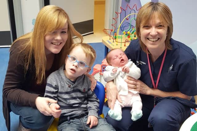 Nikki Legg and children Jameson and Alice, with midwife Ann Going
