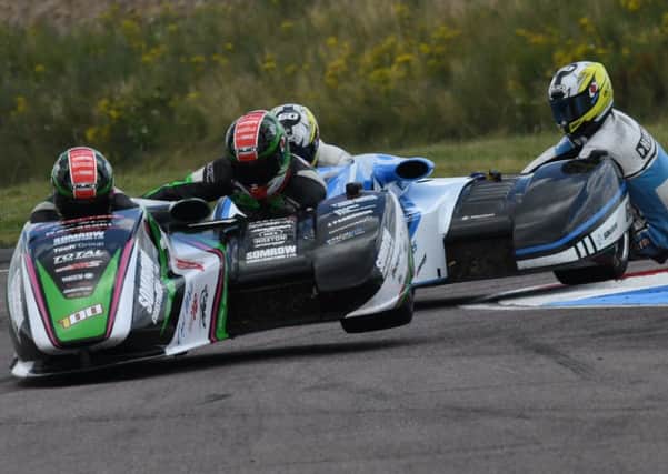 icky Stevens and passenger Ryan Charlwood hold off the challenge of Ben Holland and Lee Watson during the weekends British Formula One Sidecar Championship event at Thruxton Picture: John Mushet