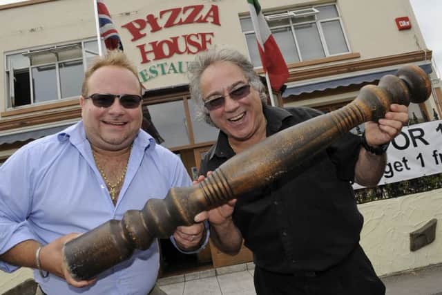 Giuseppe Mascia and his son Christian with the restaurant's famous giant pepper mill in 2013 after it was returned following a theft