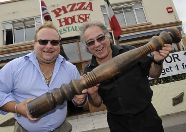 Giuseppe Mascia and his son Christian with the restaurant's famous giant pepper mill in 2013 after it was returned following a theft