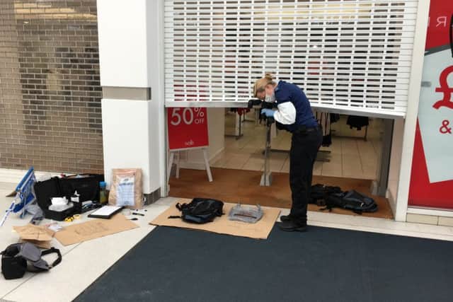 Pictured: Crime scene investigators outside the Wallis store inside the shopping centre. Thieves raided Ernest Jones in Cascades Shopping Centre in Portsmouth on July 26. Picture: Ben Fishwick PPP-160726-142026001