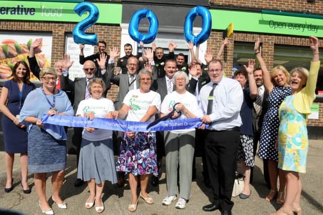 Assistant manager Nick Simms with staff from the Co-op and The Rowans Hospice at the opening of the new Purbrook store Picture: Sarah Standing (161112-9874)
