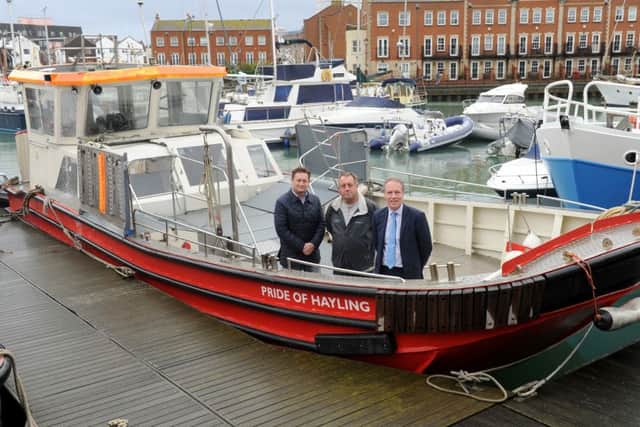 From left, ferry user and supporter Andrew Rothwell, Hayling Ferry owner Tim Trayte and Cllr Michael Wilson on the Pride of Hayling last year after work had started on the vessel
Picture: Sarah Standing (151947-4179)