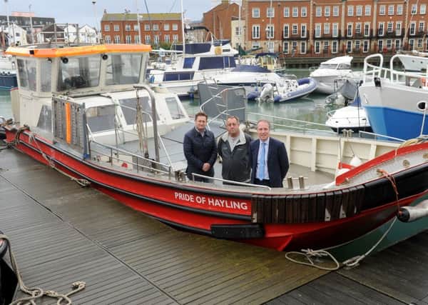 From left, ferry user and supporter Andrew Rothwell, Hayling Ferry owner Tim Trayte and Cllr Michael Wilson on the Pride of Hayling last year after work had started on the vessel
Picture: Sarah Standing (151947-4179)