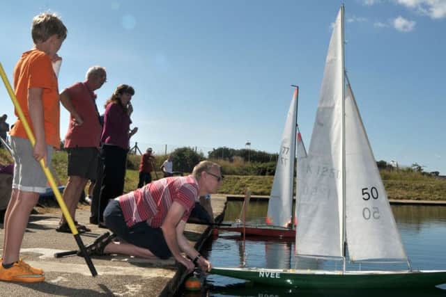 Putting one of the Vane 'A' Class model yachts into the water