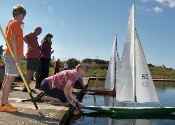 Putting one of the Vane 'A' Class model yachts into the water