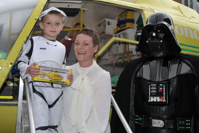As well as being made an honorary stormtrooper, Olly Banachowicz (5), with his mother Sonia, receives a model of an air ambulance at the Hampshire & Isle of Wight Air Ambulance display at Gunwharf Quays