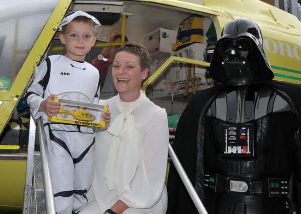 As well as being made an honorary stormtrooper, Olly Banachowicz (5), with his mother Sonia, receives a model of an air ambulance at the Hampshire & Isle of Wight Air Ambulance display at Gunwharf Quays