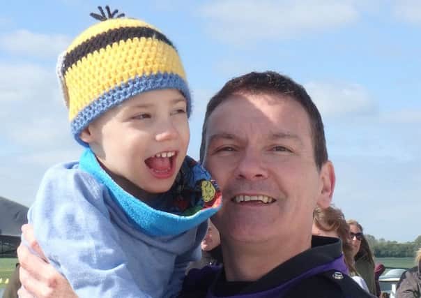 Charlie Bonnick with his father, Steve. Charlie's family are trying to raise Â£10,000 for a multi-sensory room at his home