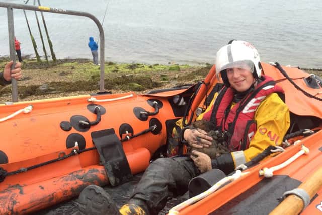 Josh in the D-Class Lifeboat cradling Minnie Mouse to keep her warm Picture: RNLI
