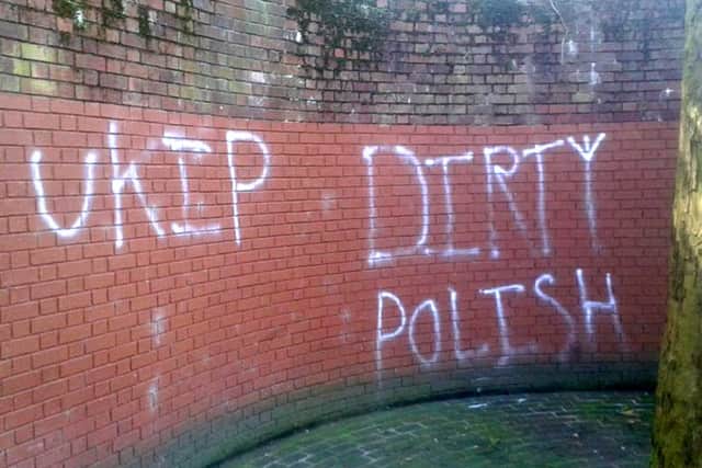Graffiti showing 'Ukip' and 'Dirty Polish' spray-painted on the wall near the war memorial at Guildhall Square in Portsmouth