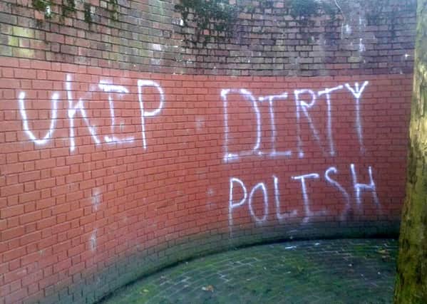 Graffiti showing 'Ukip' and 'Dirty Polish' spray-painted on the wall near the war memorial at Guildhall Square in Portsmouth