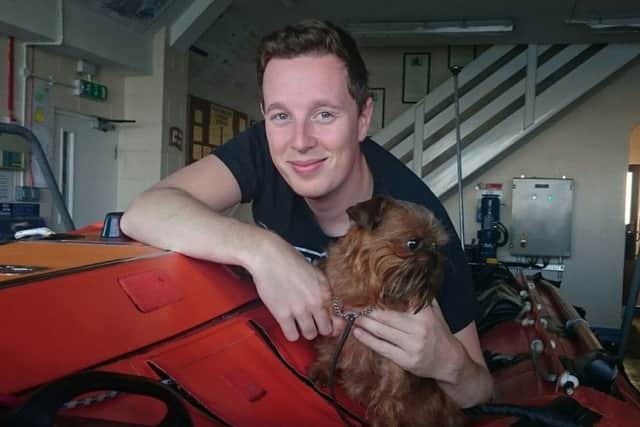 Trainee lifeboat crewman Joshua Bowe is reunited with Minnie Mouse the dog after helping to rescue it from Langstone Harbour earlier this week. PHOTO: Aaron Gent, RNLI ID27uN1wu7S8XEx_e5Oj