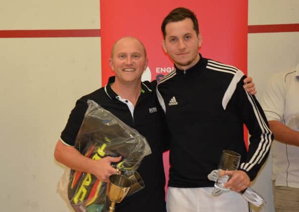 Tim Vail, left, celebrates his eight national racketball title win last month
