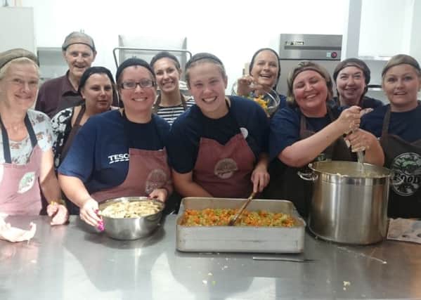 Tesco volunteers at King's Church preparing dinner for the FoodCycle project Picture: Miles O'Leary