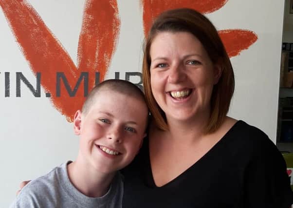 Jake Barker, 12, with his mum Terri Barber after the shave
