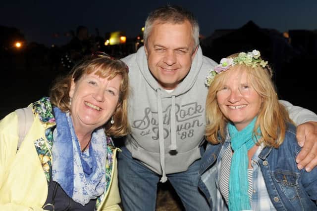From left, Sharon Halifax from Stubbington, enjoying her first festival with friends Paul Cadman and Jane Cadman from Bishop's Waltham. 

Picture: Sarah Standing (161124-972)