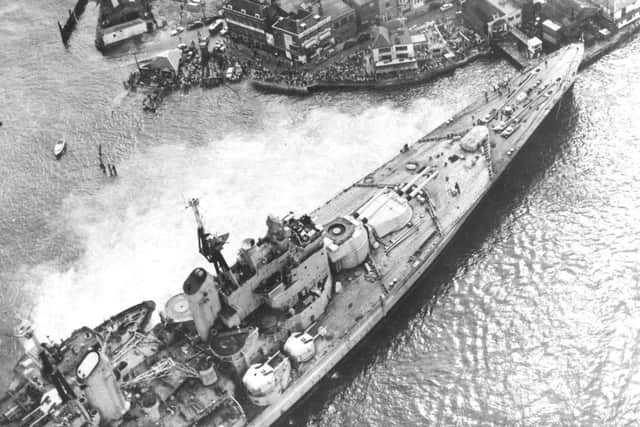 Spectators flock to see HMS Vanguard aground in Portsmouth Harbour, 1960