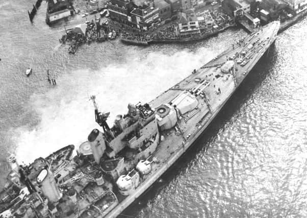 Spectators flock to see HMS Vanguard aground in Portsmouth Harbour, 1960