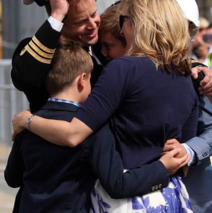 Commander Hutchings, CO of HMS St.Albans, welcomed home by his family