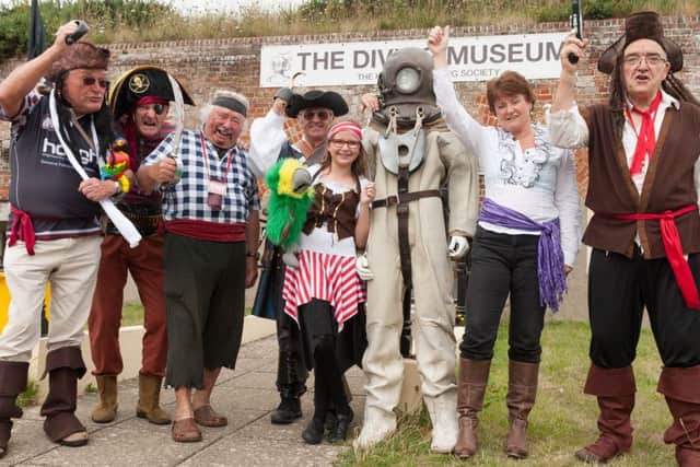Members and volunteers dressed as pirates greet the public at the entrance to the diving museum Pictures: Keith Woodland (160003-003)
