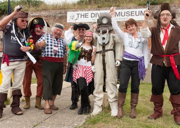 Members and volunteers dressed as pirates greet the public at the entrance to the diving museum Pictures: Keith Woodland (160003-003)