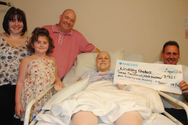 Lindsey Gates with her husband Jason and children Brooke and Charley, and right, Shane Yerrell from the charity Through the FightHe donated Â£3,921 to her to help pay for her funeral