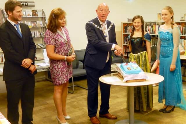 From left, Southsea library manager Dan James, Deputy Lady Mayoress Jo Ellcome, Deputy Mayor Ken Ellcome, Faith Winning as Ana from Frozen and Zoe Barker as Elsa from Frozen