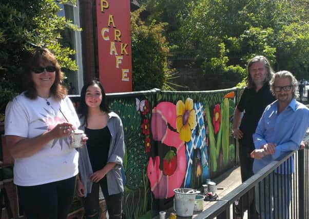 From left, volunteer artists Lorrie Slee and Serena Wild, Ben Baxter of The Broken Republic and Lodge Arts Centre owner Mark Lewis, next to the new Save the Lodge mural alongside The Lodge in Victoria Park