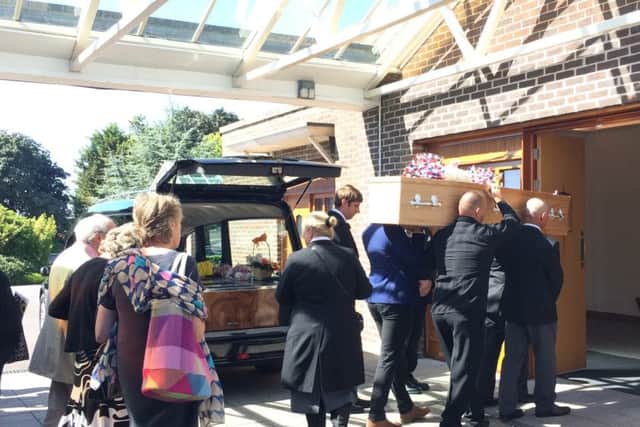 The casket of Ray King is taken in to Portchester Crematorium today