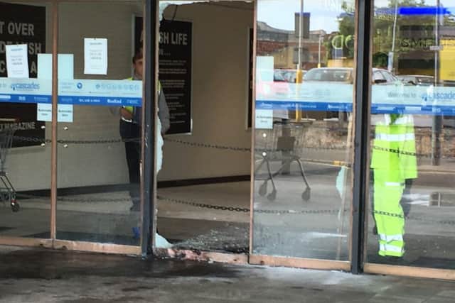 Pictured: Workers clean up the remains of a fire in Charlotte Street after a raid at a jewellery store. Thieves raided Ernest Jones in Cascades Shopping Centre in Portsmouth on July 26. Picture: Ben Fishwick PPP-160726-142157001