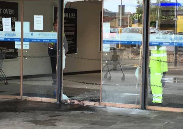 Pictured: Workers clean up the remains of a fire in Charlotte Street after a raid at a jewellery store. Thieves raided Ernest Jones in Cascades Shopping Centre in Portsmouth on July 26. Picture: Ben Fishwick PPP-160726-142157001