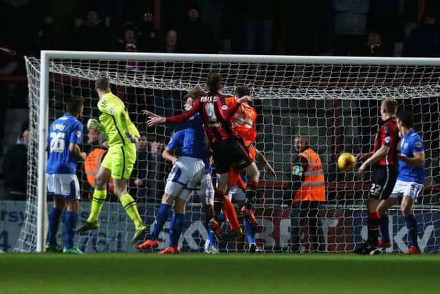 Morecambe keeper Barry Roche heads home for the Shrimps. Picture: Joe Pepler