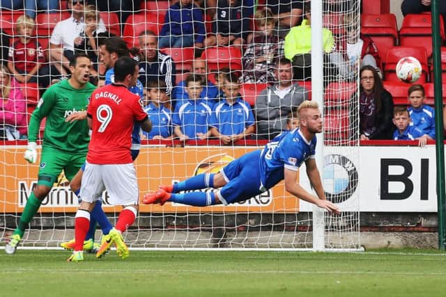 Pompey defender Jack Whatmough heads clear at Crewe yesterday Picture: Joe Pepler