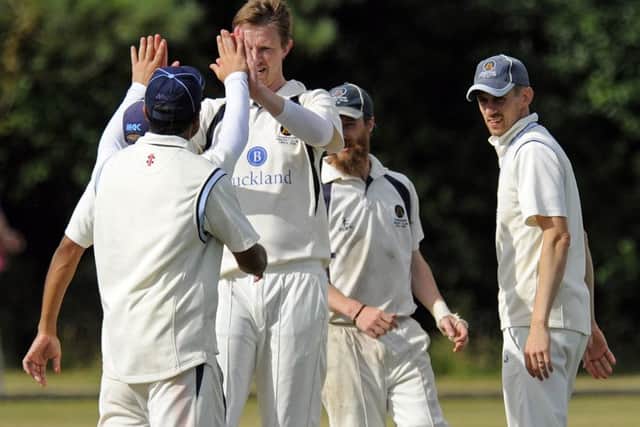 Rupert Hetherington celebrates a wicket in Hambledon's victory over Calmore. Picture: Malcolm Wells (160813-5705)