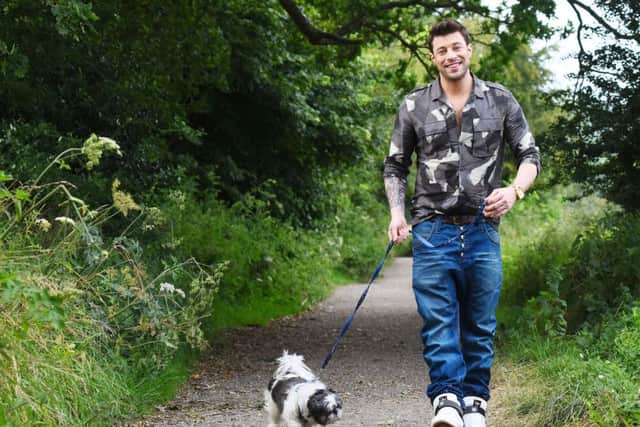 Duncan James walking a blind dog, nine-year-old Shih Tzu Tallula, through the South Downs National Park.
Picture: Solent News & Pictures