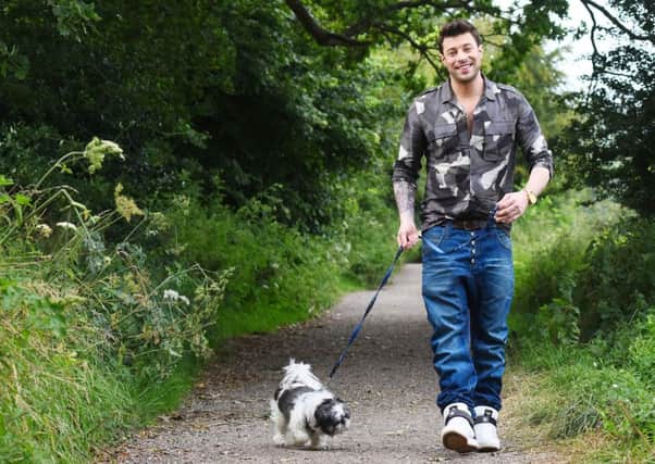 Duncan James walking a blind dog, nine-year-old Shih Tzu Tallula, through the South Downs National Park.
Picture: Solent News & Pictures