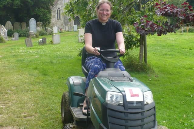 The Rev Jenny Gaffin, vicar of St Marys, St Peters and St Andrews on Hayling Island, is taught how to use the mower in St Marys churchyard