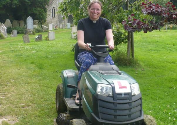 The Rev Jenny Gaffin, vicar of St Marys, St Peters and St Andrews on Hayling Island, is taught how to use the mower in St Marys churchyard