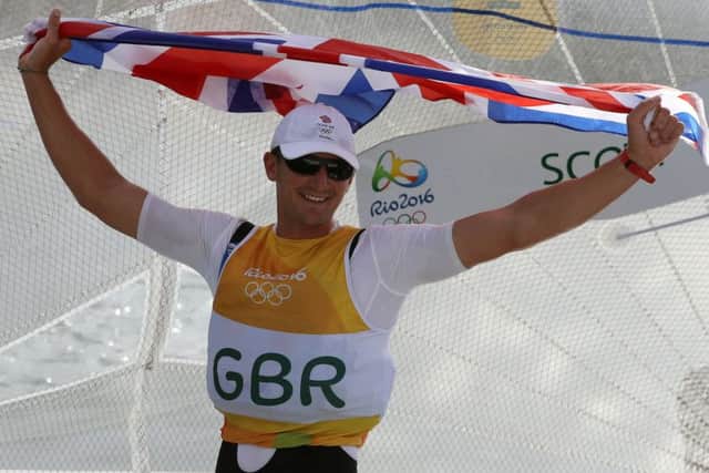 Land Rover BARs Giles Scott celebrates victory in the Finn heavyweight dinghy class Picture: Martin Rickett/PA Wire.