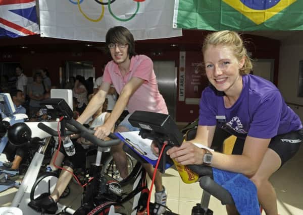 Alex Halladay, left, from Gosport gets pedalling with physiotherapist and charity cycle organiser Harriett Herbert who works in the stroke department at QA 
Picture: Ian Hargreaves (161105-1)
