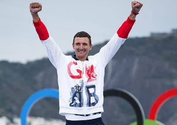 Giles Scott steps on to the podium to claim his Finn gold medal in Rio Picture: Richard Langdon/British Sailing Team