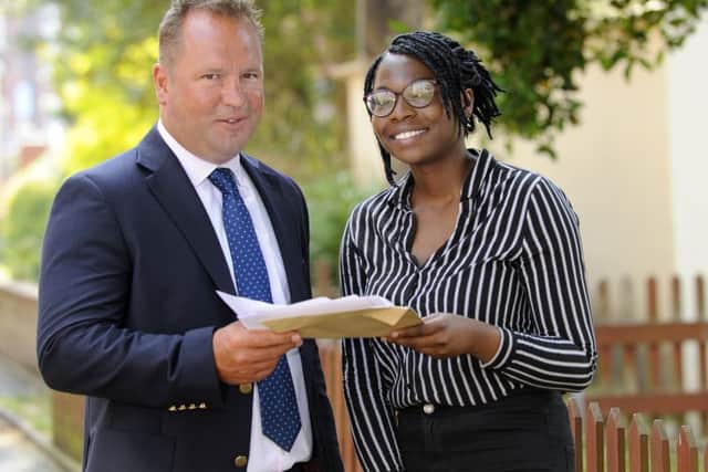 Deputy head girl Esther Olanihun, 18, is congratulated by head of St John's College Tim Bayley Picture: Malcolm Wells (160818-6341)