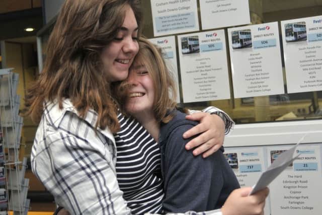 Phoebe Millin, 17, and Britney Walker, 17, check their results at South Downs College
Picture: Mick Young
(161080-05)