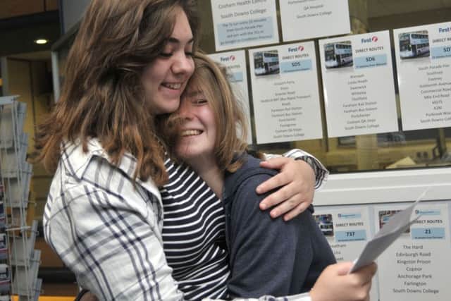 Phoebe Millin, 17, and Britney Walker, 17, check their results at South Downs College 
Picture: Mick Young
 (161080-05)