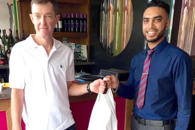 Robert Capel picking up a takeaway for his parents in Spain from Kaz Miah, the owner of Pasha